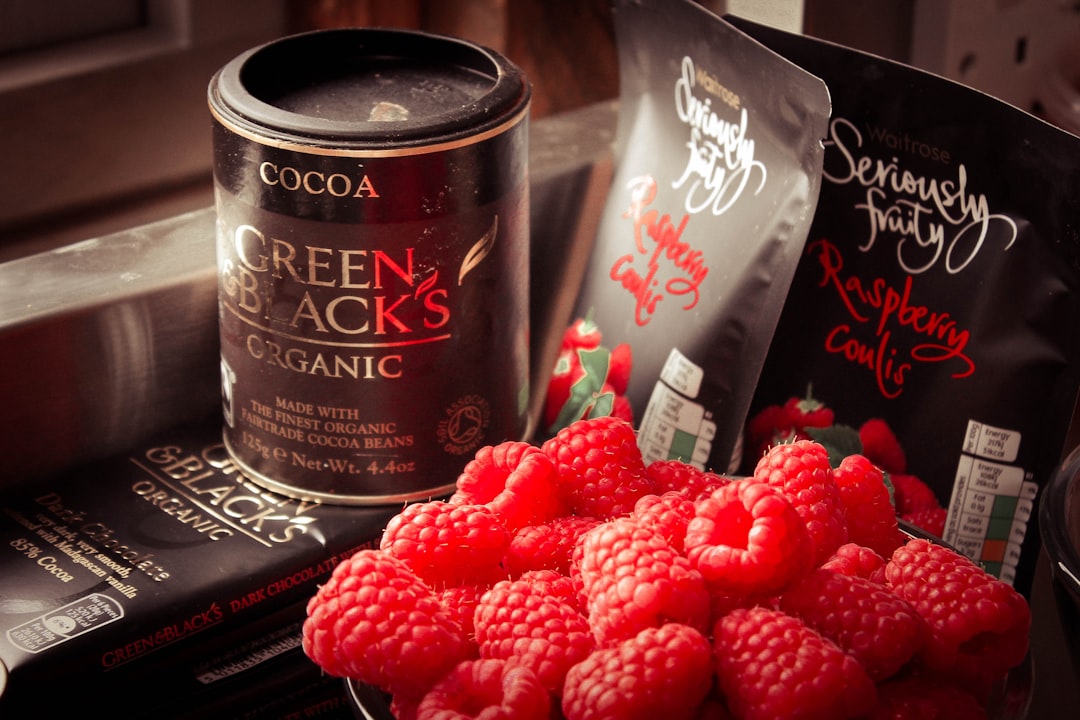 Cocoa Green & Black's can and bunch of raspberries