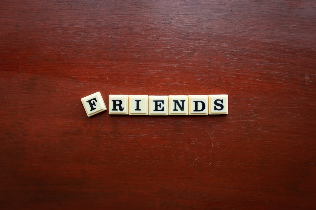the word friends spelled with scrabbles on a wooden surface